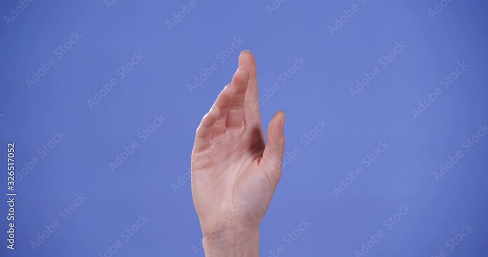 Woman showing F letter on blue background, closeup. Sign language Woman showing F letter on blue background, closeup. Sign language