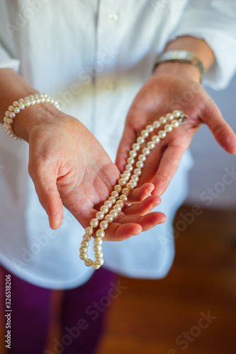 Woman's Hand Holding Pearls