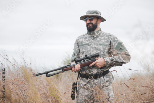 smiling hunter with shotgun