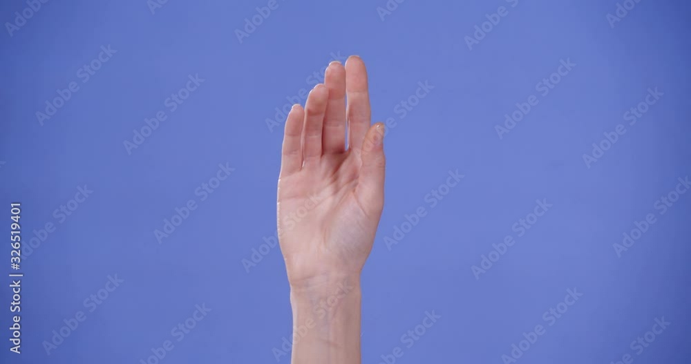 Woman showing O letter on blue background, closeup. Sign language Woman showing O letter on blue background, closeup. Sign language