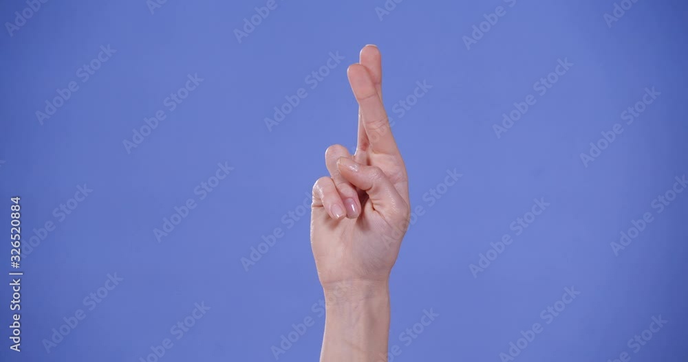 Woman showing R letter on blue background, closeup. Sign language Woman showing R letter on blue background, closeup. Sign language