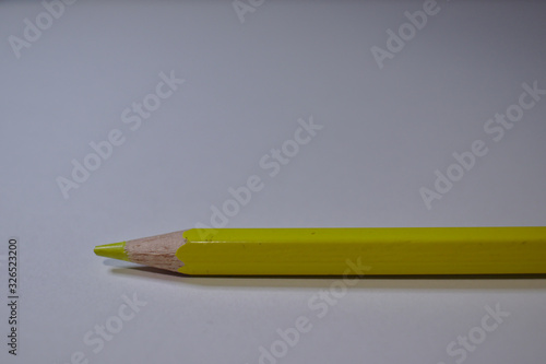 Yellow pencil sitting on white desk