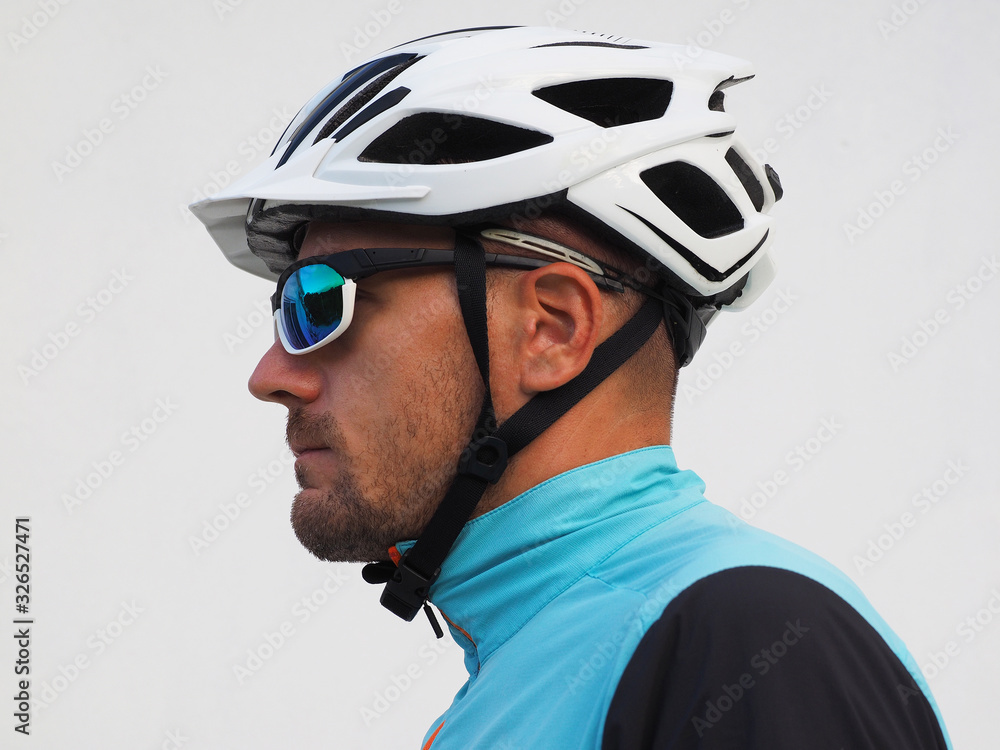 Profile of a cyclist, wearing a helmet and sunglasses. Profile of a cyclist, wearing a helmet and sunglasses.