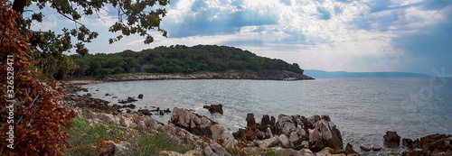 Panoramic view of rocky coastline and green cape at the sea of Kijac beach on Krk island, Croatia. photo