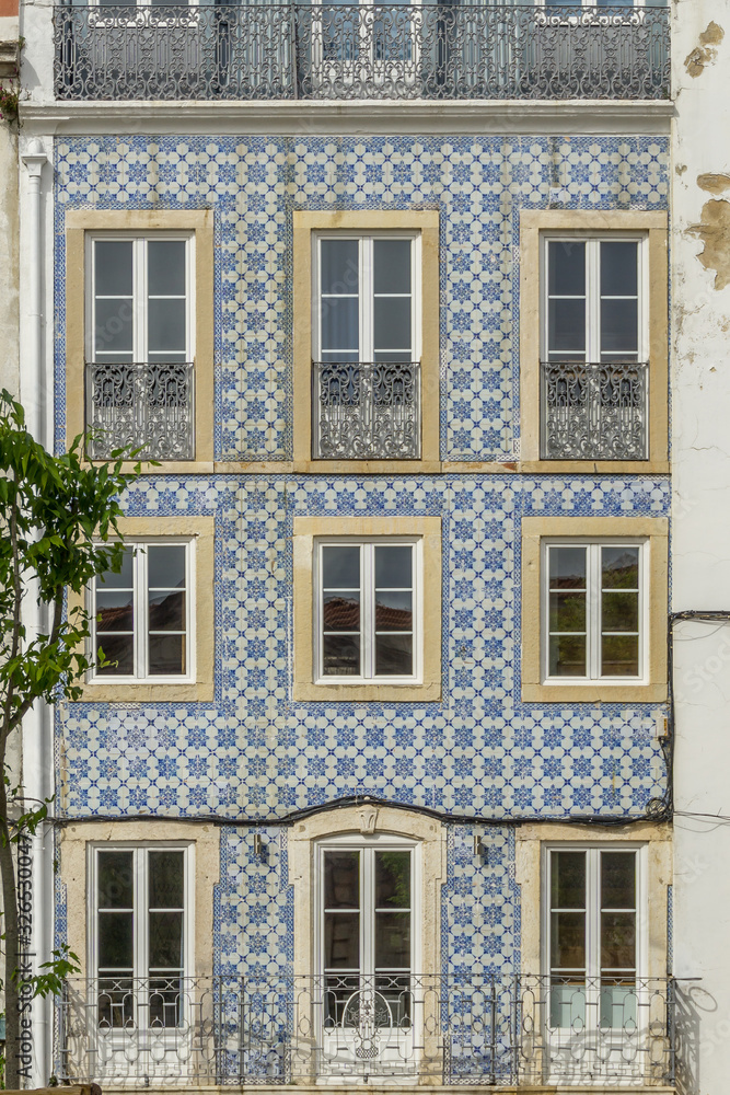 Tile covered colourful building exterior in Lisbon, Portugal.