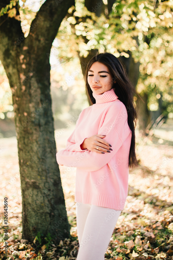 Beautiful model posing for the camera in the park. Beautiful model posing for the camera in the park.