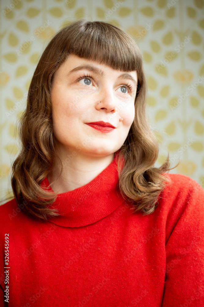 Portrait of a young red head woman having fun in front of a camera. Portrait of a young red head woman having fun in front of a camera.