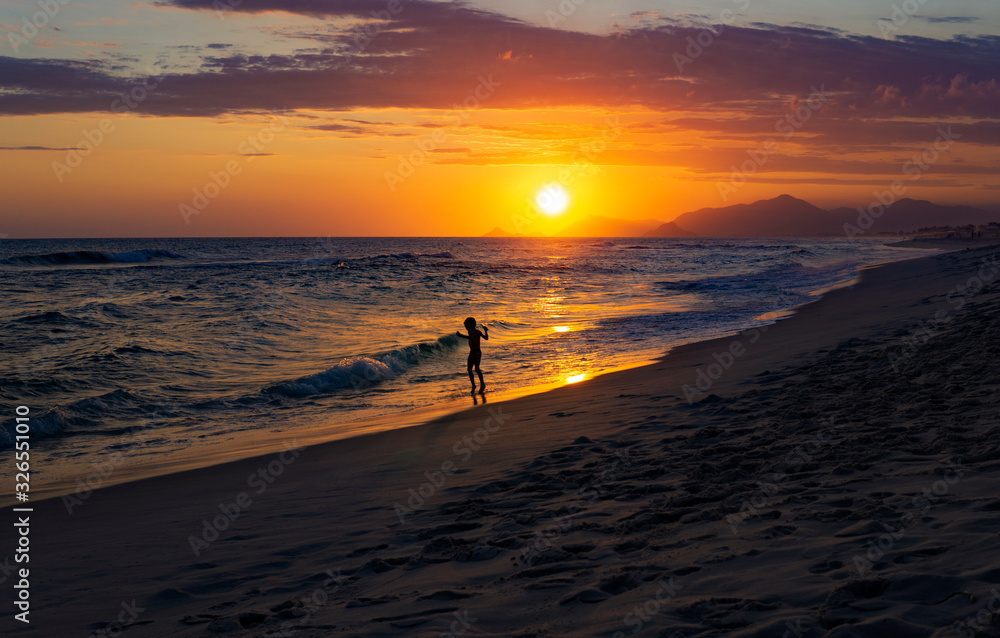 Silhouette Of Child Playing On Exotic Beach With Beautiful Sunset 