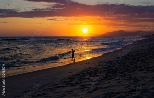 Silhouette Of Child Playing On Exotic Beach With Beautiful Sunset  © Joshua