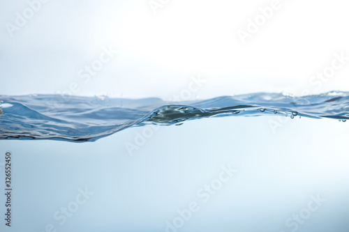 Water splash. Aqua flowing in waves and creating bubbles. Drops on the water surface feel fresh and clean. isolated on white background.