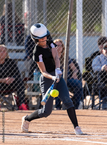 Canvas-taulu Female high school softball player flinging the bat aside as she postures to spint up the first base line