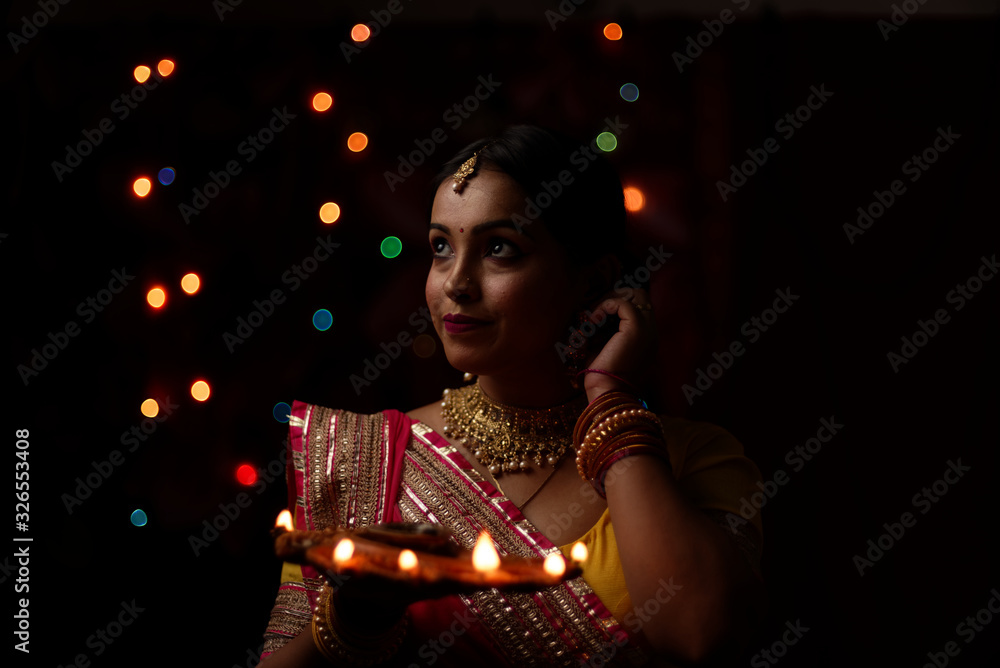 An young and beautiful Indian Bengali woman in Indian traditional dress