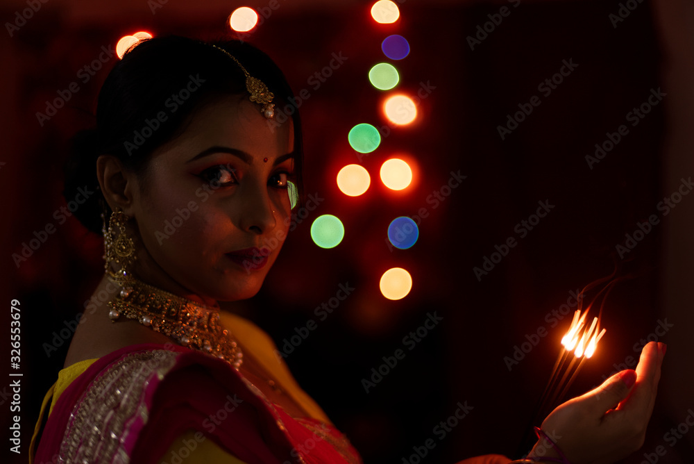 An young and beautiful Indian Bengali woman in Indian traditional dress