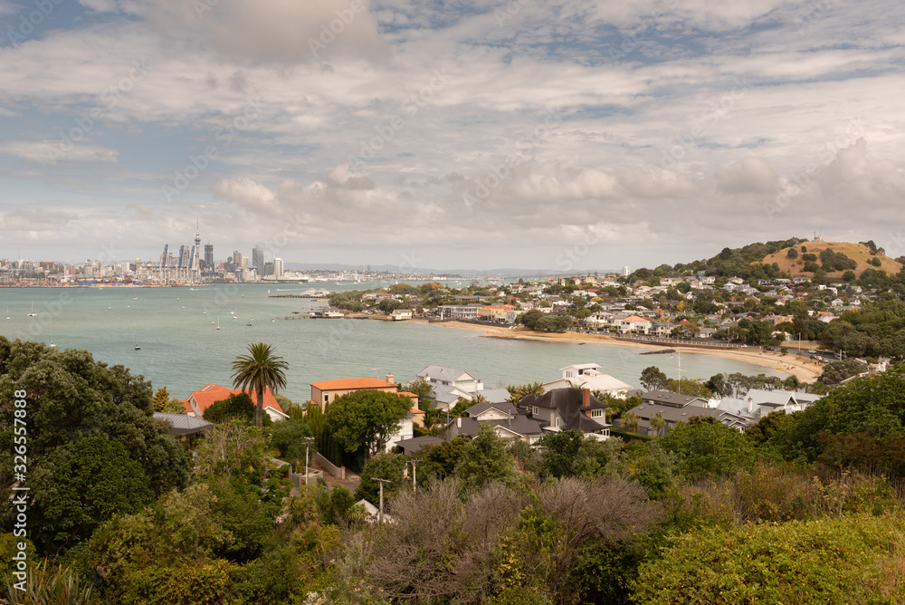 Fototapeta premium The view from North Head over the beach at Torpedo Bay and Devonport, across the Waitemata Harbour to Auckland City and the port in the background.