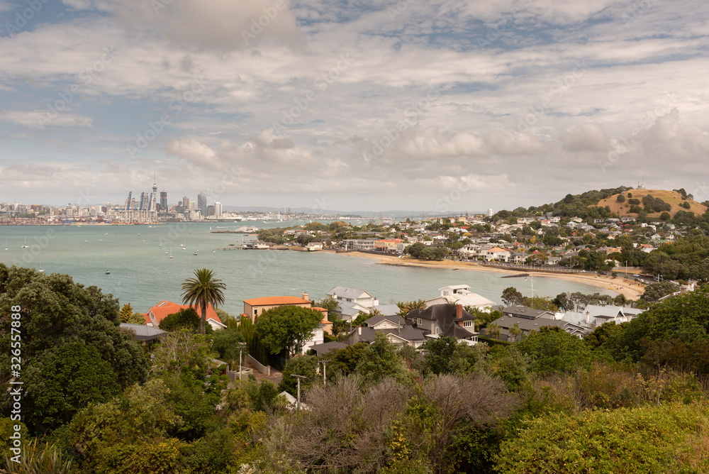 The view from North Head over the beach at Torpedo Bay and Devonport, across the Waitemata Harbour to Auckland City and the port in the background.