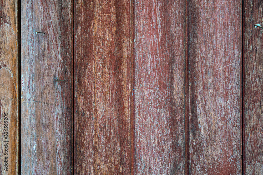A texture of aged red wooden from old house A texture of aged red wooden from old house