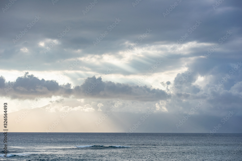 Fototapeta premium heavenly ray of light, between clouds over the ocean