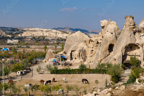 Farm surrounded by cave houses carved in stone at Göreme, Cappadocia, Turkey