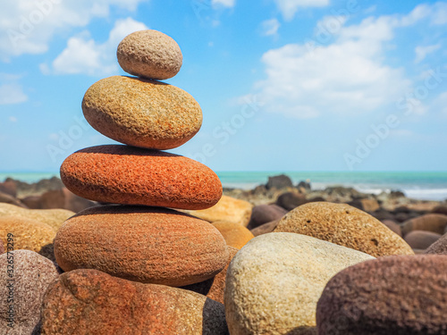 Stack balance pepples on pepples beach on freshness day aginst blue sky   use for background