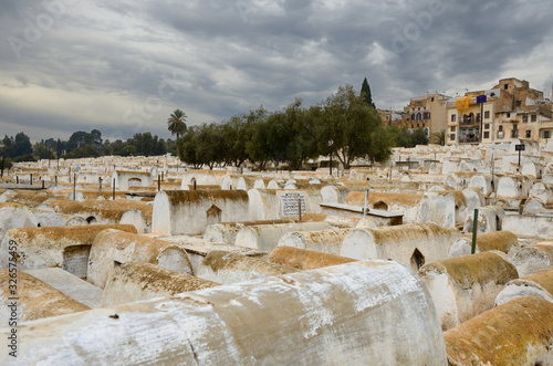 Large Jewish cemetery in the Mellah of Fes el Jedid Morocco with storm clouds photo