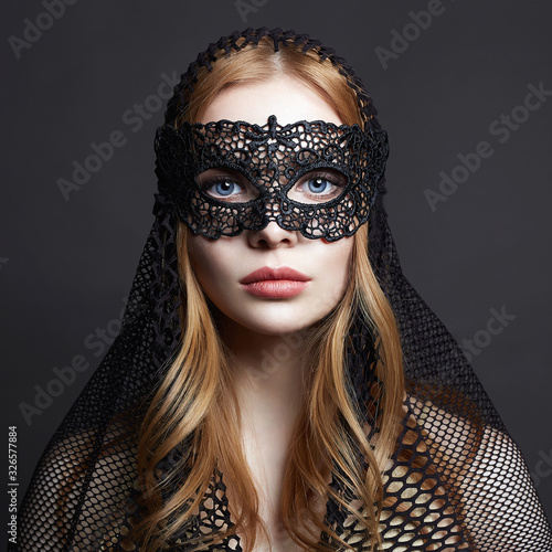 Beautiful young Woman in a Carnival Mask