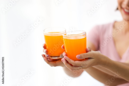 Happy young couple friend beautiful asia women drinking orange juice enjoying fruit refreshment ,Healthy lifestyle concept.