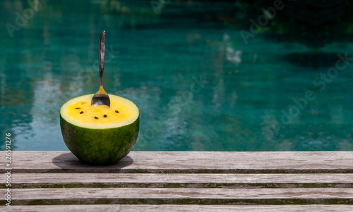 yellow watermelon with the spoon in the pool
