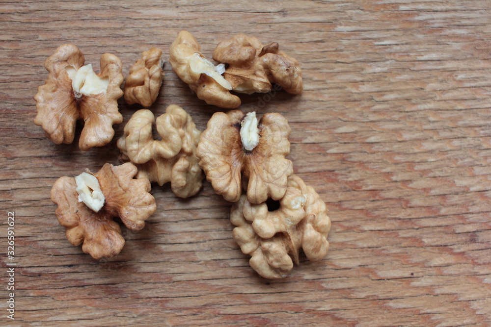 Closeup of peeled walnuts on wooden background Closeup of peeled walnuts on wooden background
