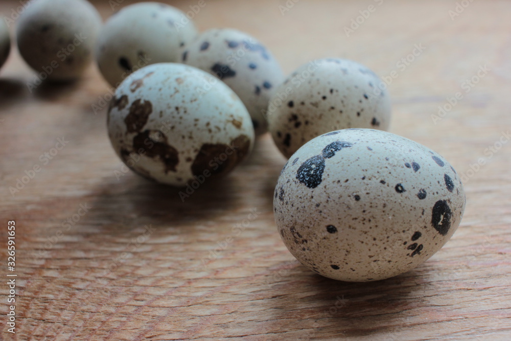 Obraz premium Closeup of quail eggs on wooden background