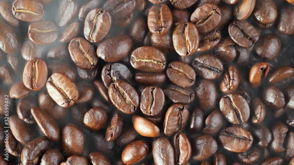Hot and steaming coffee beans are mixed while roasting Hot and steaming coffee beans are mixed while roasting