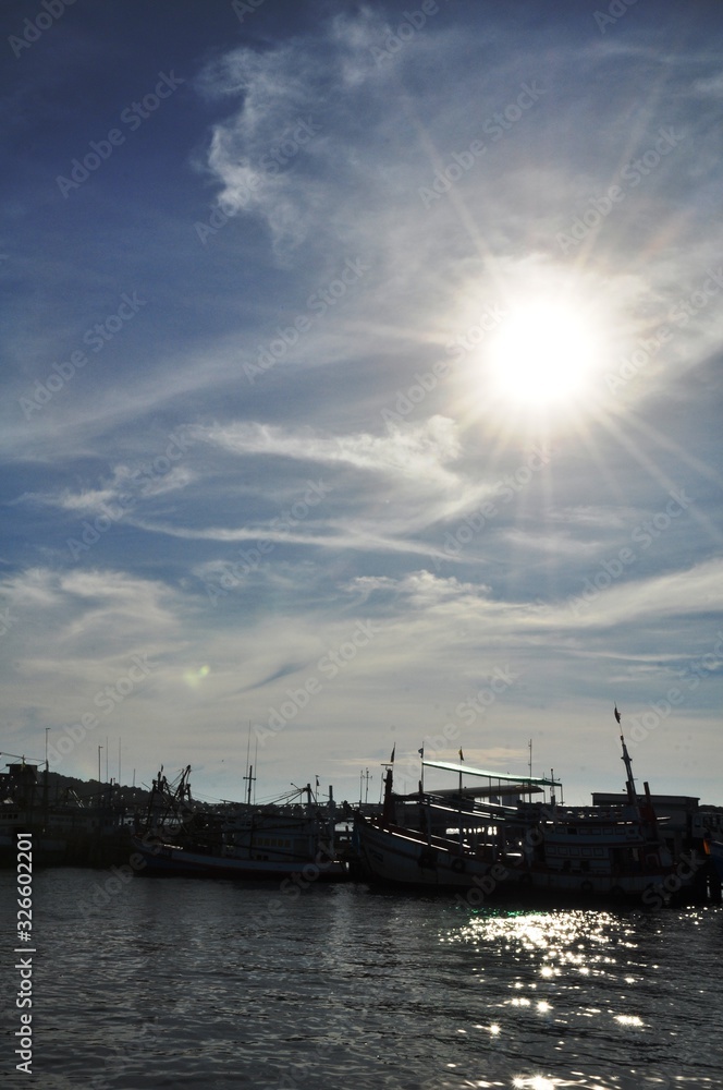 View of Thai fishing port on a clear bright day. View of Thai fishing port on a clear bright day.