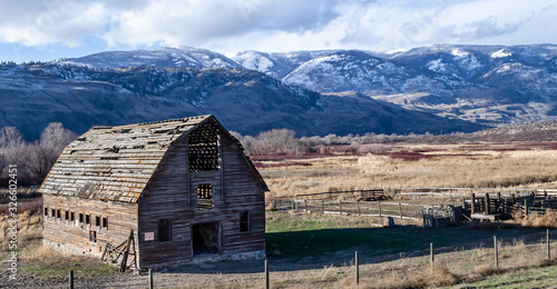 Haynes Ranch, Osoyoos, Okanagan Valley, British Columbia. Heritage Barn with Winter Snow Capped Mountains in Background photo