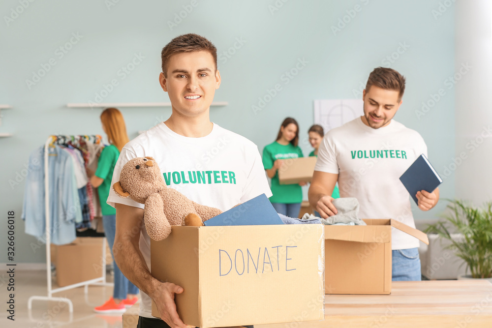 Volunteers with donations for poor people indoors Volunteers with donations for poor people indoors
