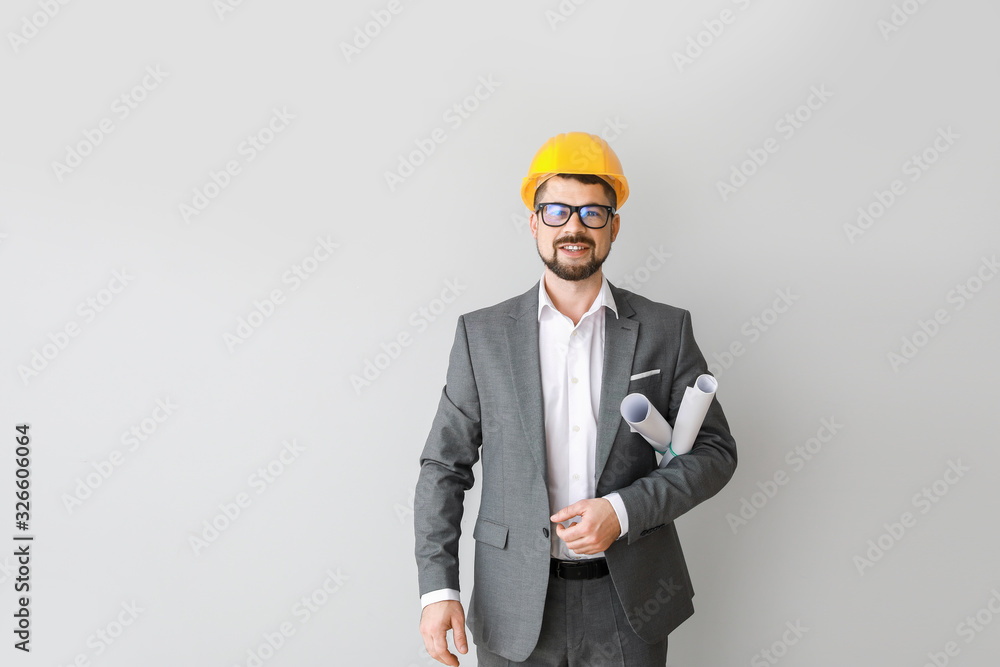 Male engineer with drawings on light background Male engineer with drawings on light background