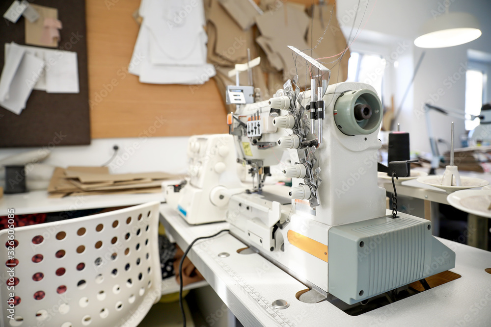 Modern sewing equipment in tailor workshop