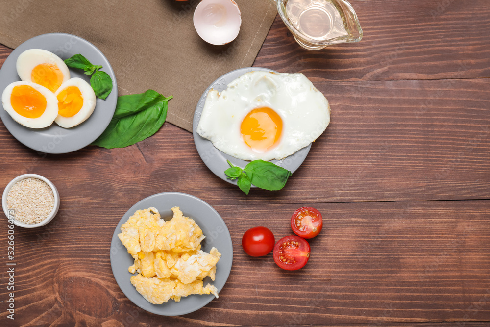 Different tasty dishes with eggs on wooden table Different tasty dishes with eggs on wooden table