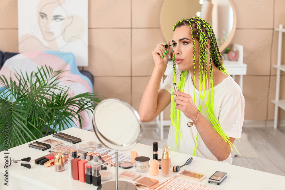 Transgender woman applying makeup at home Transgender woman applying makeup at home