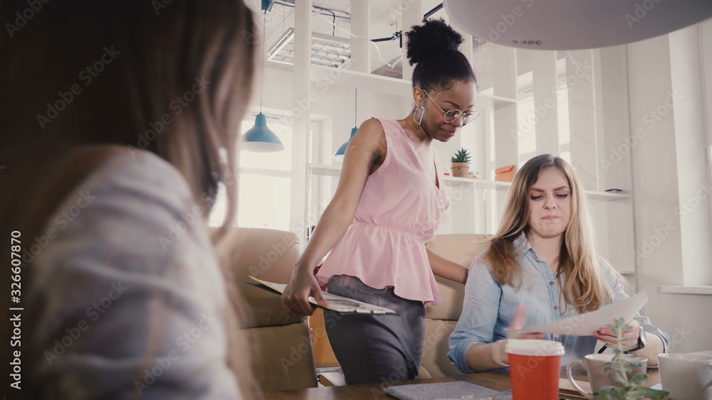 Happy black female manager inspires employees. Mixed ethnicity young smiling people work in modern loft trendy office 4K Happy black female manager inspires employees. Mixed ethnicity young smiling people work in modern loft trendy office 4K