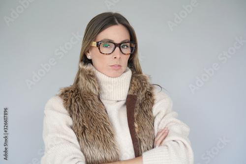 Portrait of stylish woman with furry jacket and eyeglasses on