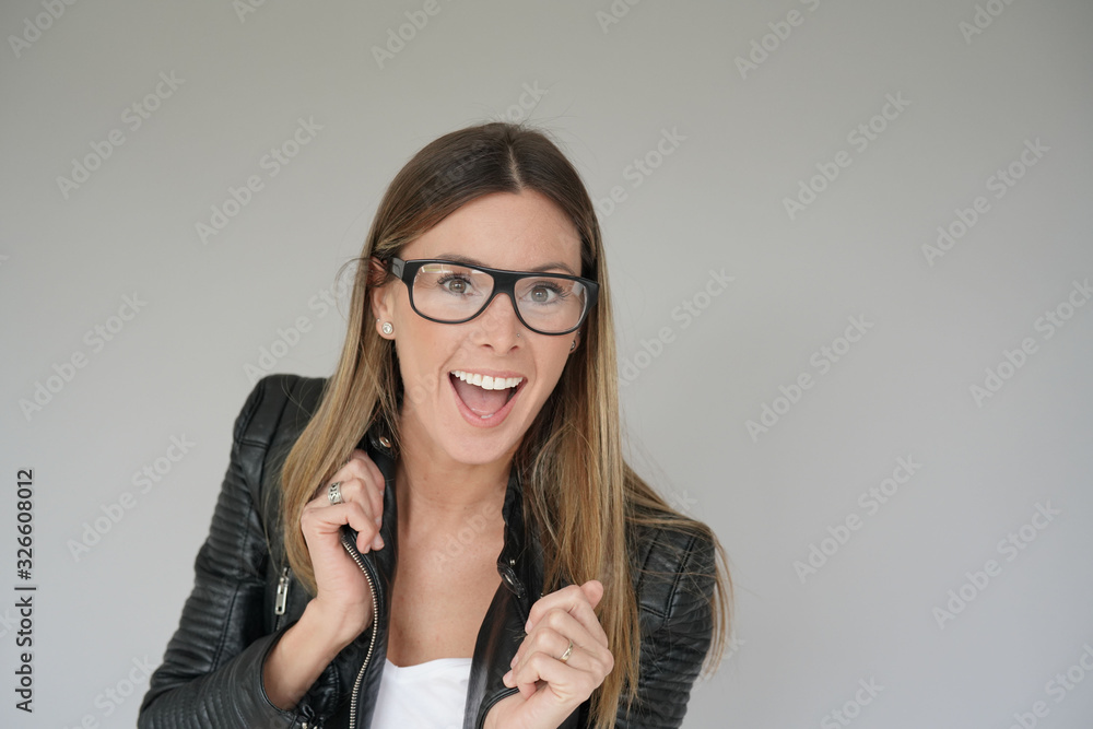Trendy girl wearing leather jacket and trendy glasses, isolated Trendy girl wearing leather jacket and trendy glasses, isolated
