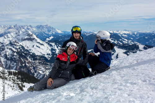 Family, skiing in winter ski resort on a sunny day, enjoying landscape
