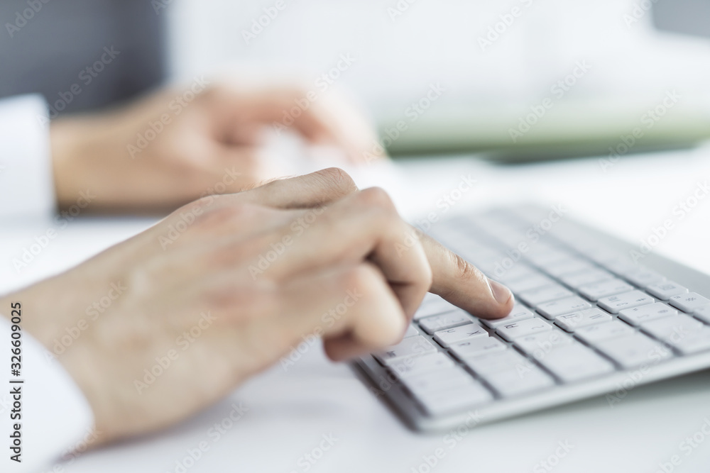 Man hands typing on computer keyboard in sunny office, business and technology concept. Close up Man hands typing on computer keyboard in sunny office, business and technology concept. Close up