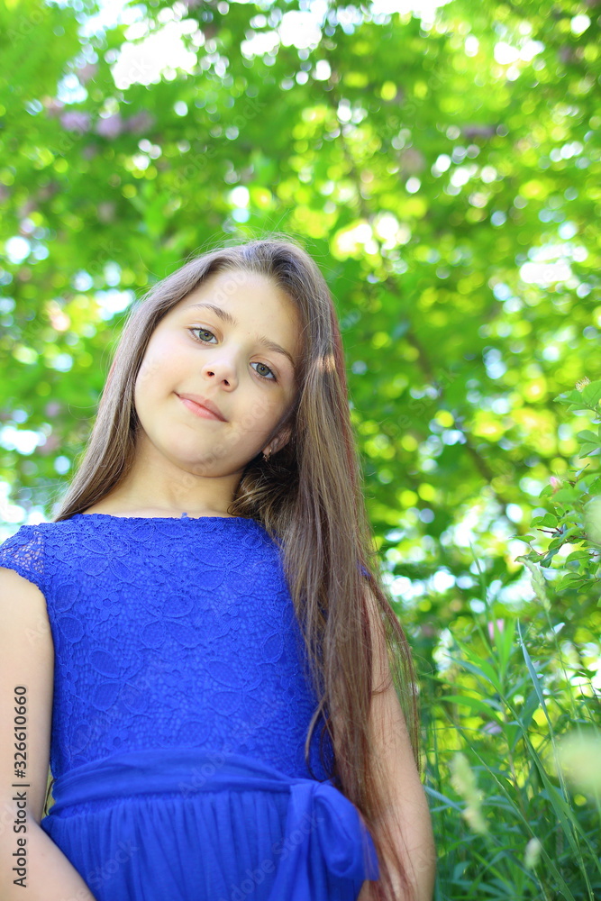 beautiful girl in a blue dress with a bouquet of daisies and a wreath of wildflowers in the summer botanical garden beautiful girl in a blue dress with a bouquet of daisies and a wreath of wildflowers in the summer botanical garden