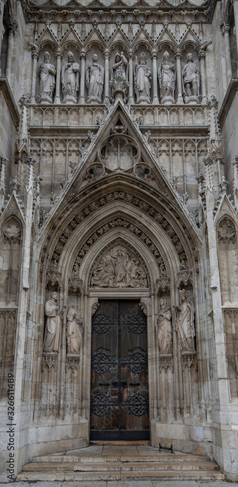 Door or gate of Neo-Gothic Votive Church (Votivkirche) on Ringstrasse - second-tallest church in Vienna, Austria. Church consecrated in 1879 on occasion of Imperial Couple's Silver Wedding.