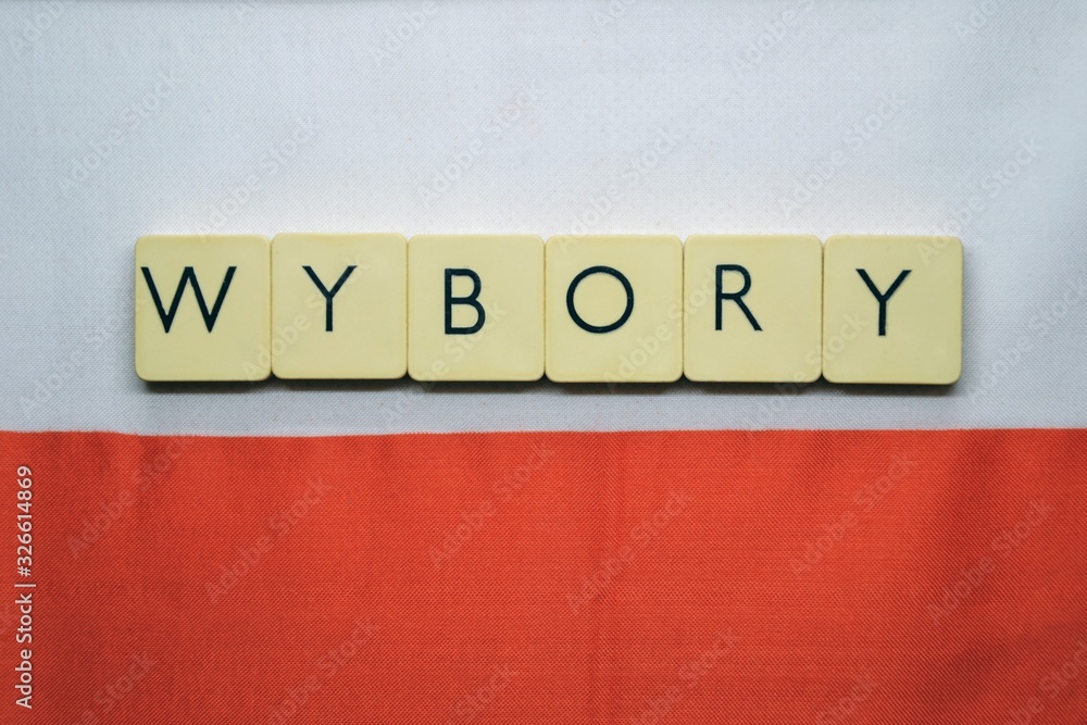 ELECTIONS (polish: wybory) word made from  game tiles with letters.  Selective focus. Elections in Poland theme. Letters on the background with white and red flag of Poland - obrazy, fototapety, plakaty 