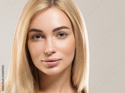 Beautiful face woman with long blonde smooth hair healthy skin natural fashion make up