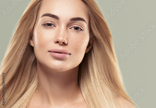 Beautiful face woman with long blonde smooth hair healthy skin natural fashion make up