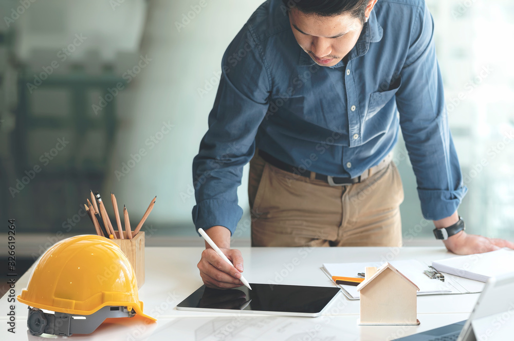 Engineer using tablet working at office, construction engineering. Engineer using tablet working at office, construction engineering.