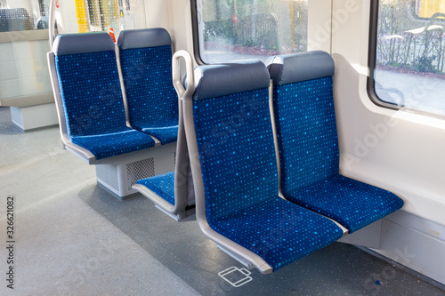 Wörthsee, Bavaria / Germany - Dec 29, 2019: Four blue seats inside a train. Interior decoration of an empty S-Bahn (Munich public transport). No people.