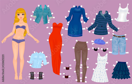 Paper doll of a pretty blond girl with a variety of paper clothes and shoes photo
